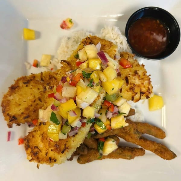 Coconut-crusted fish with mango salsa, rice, fried green beans, and a side of sauce.